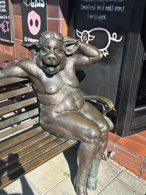 Full sized statue of a pig woman